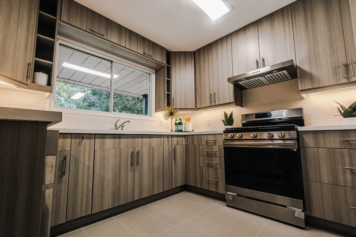 Close-up of the designer kitchen's gas range and high-end cabinetry finishes at 110 Holliday Dr.