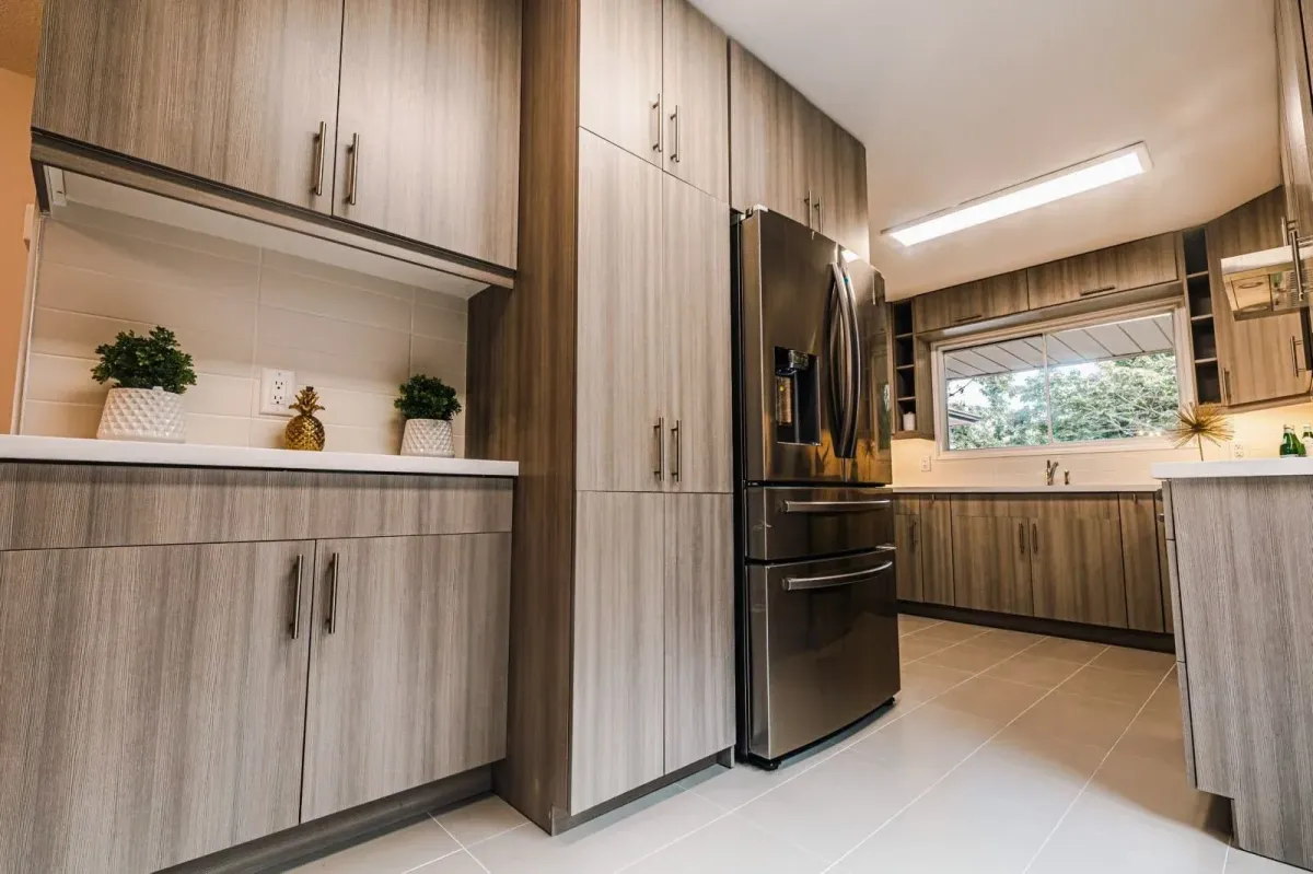 Gourmet kitchen view at 110 Holliday Dr showing the integrated stainless steel refrigerator and ample cabinet storage.