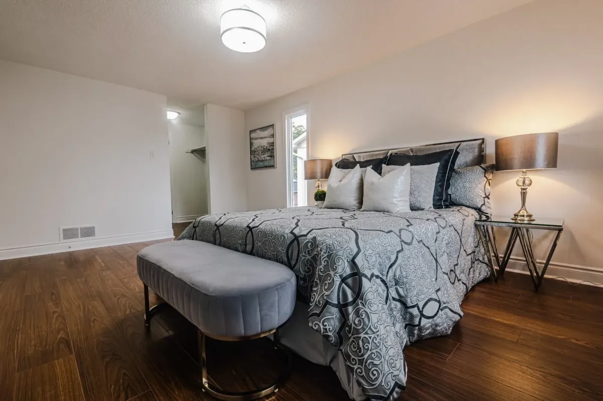 Primary bedroom retreat at 110 Holliday Dr with large windows, neutral bedding, and a spacious layout.