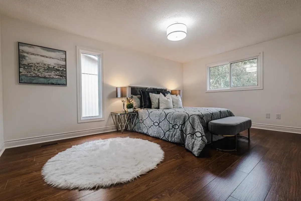Secondary view of the primary bedroom at 110 Holliday Dr showing the modern lighting and plush décor.