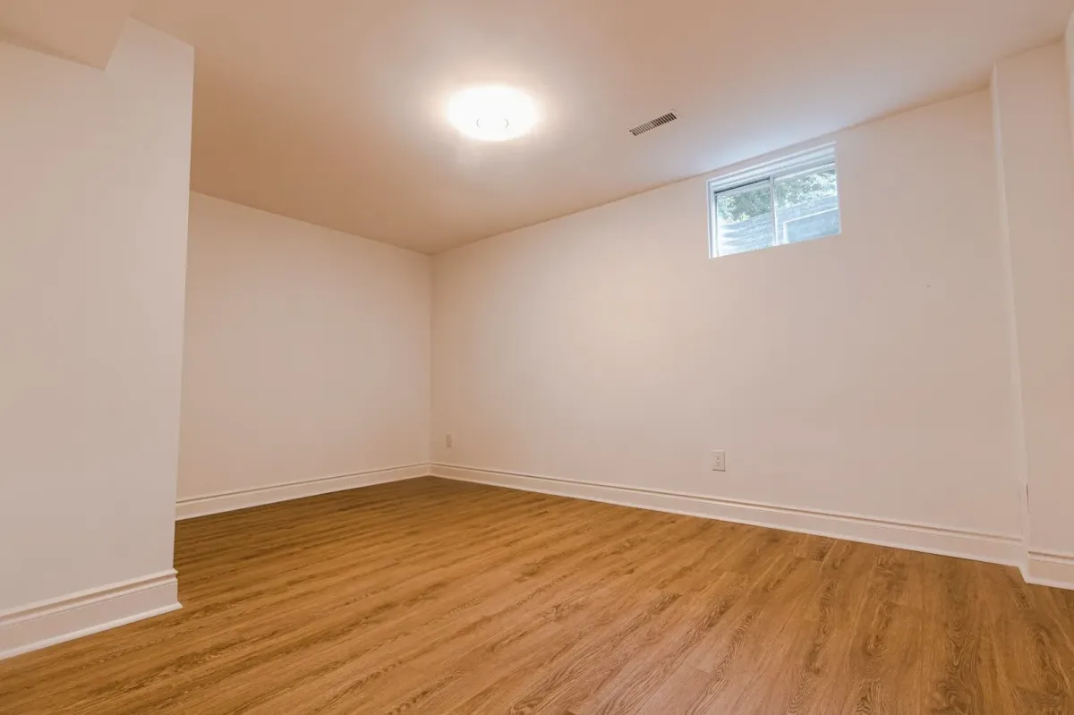 Additional basement living space at 110 Holliday Dr showing the high ceilings and clean finishes.