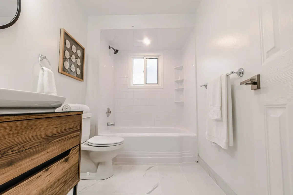 Clean, modern basement 4-piece bathroom at 110 Holliday Dr with a tiled bathtub and shower.