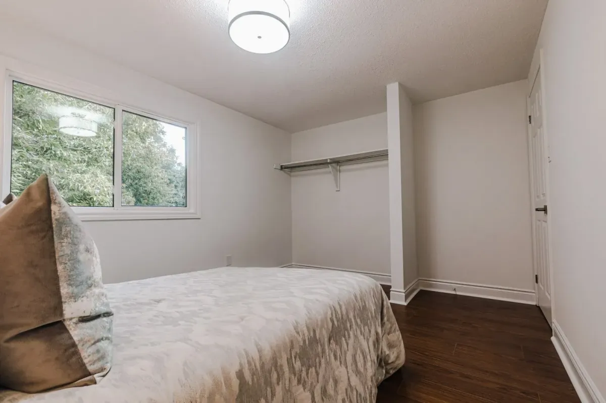 Secondary basement bedroom at 110 Holliday Dr featuring a large window and neutral walls.