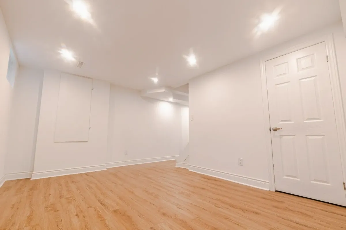 Spacious open-concept basement living area at 110 Holliday Dr with pot lights and durable flooring.