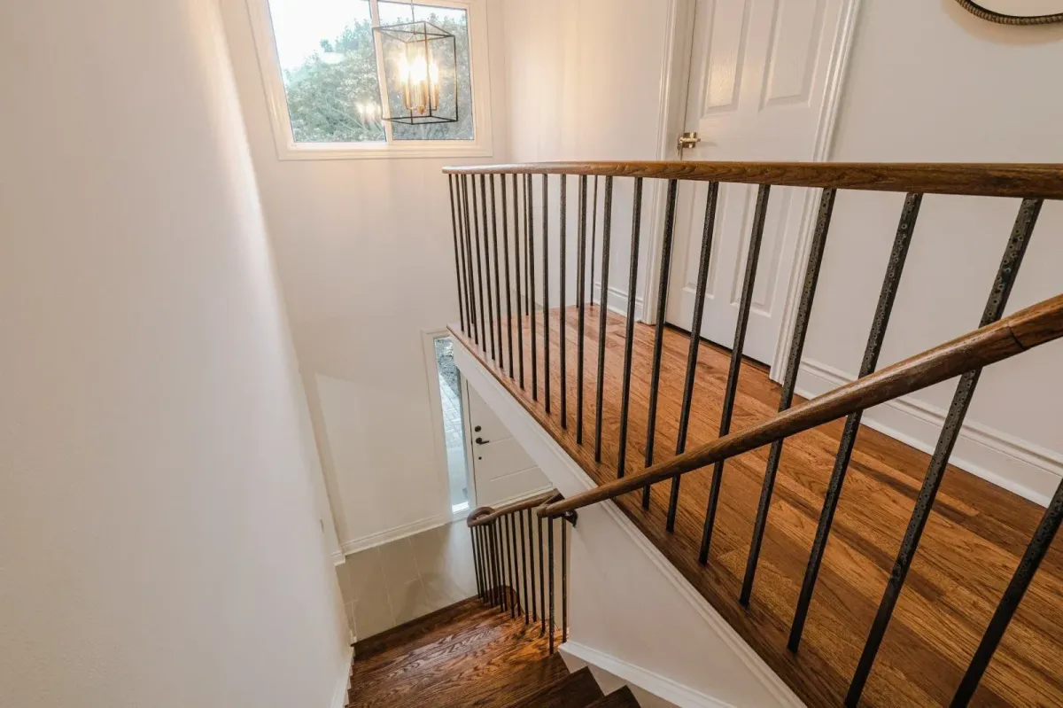 View of the wood staircase at 110 Holliday Dr leading from the second floor to the main level.