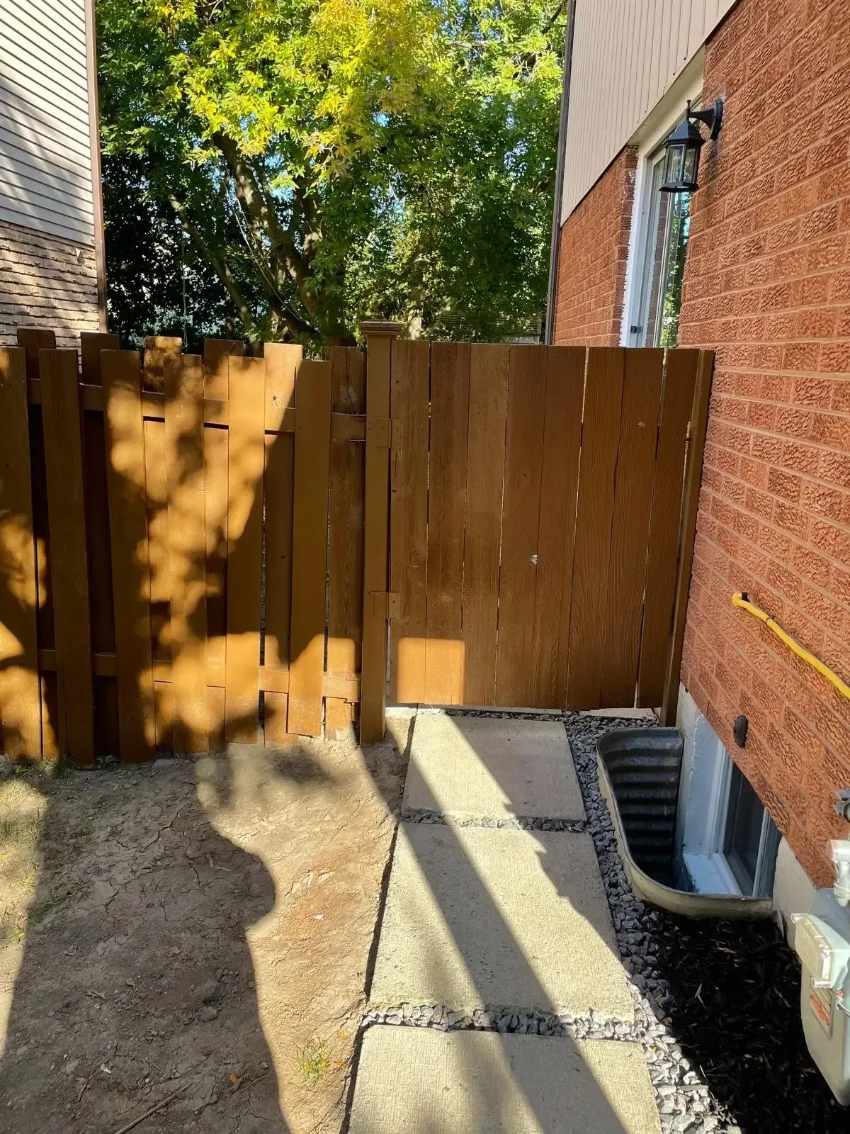 View of the wood fence and side yard access at 110 Holliday Dr.