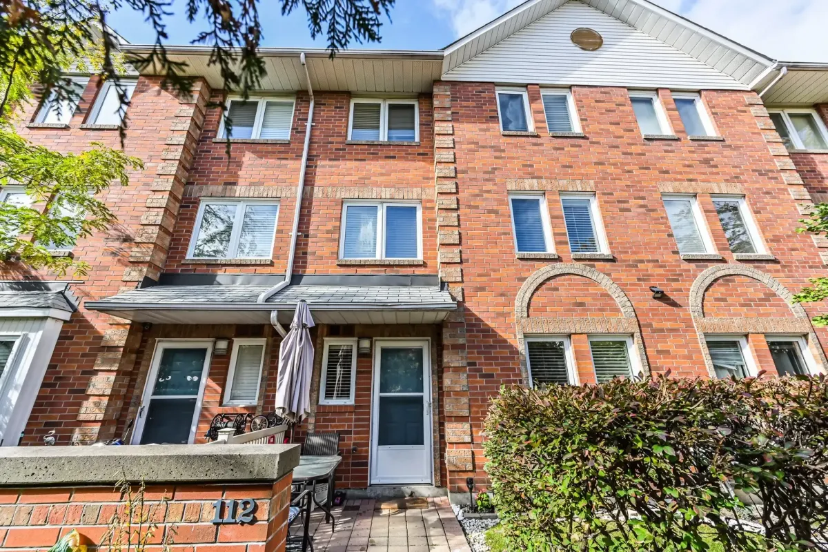 Red brick exterior of the Tridel-built Plaza Del Sol townhouse at 900 Steeles Ave W #112.