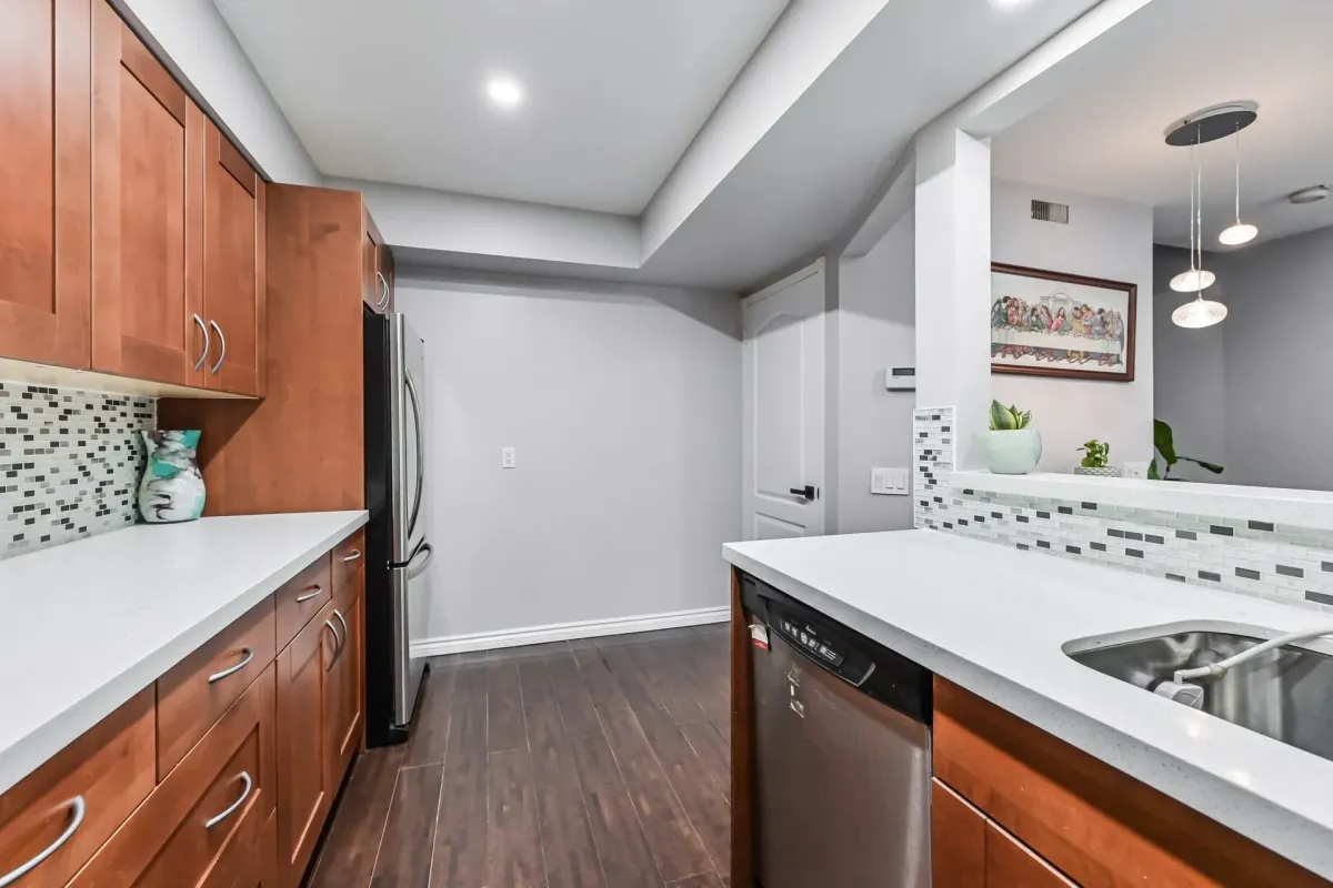 View of the quartz breakfast bar and kitchen transition at 900 Steeles Ave W #112.