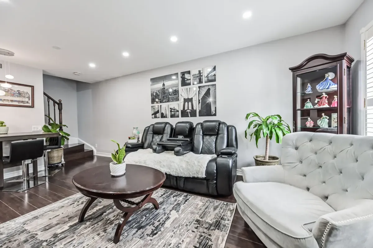 Open-concept living room with vaulted ceilings and laminate flooring at 900 Steeles Ave W #112.