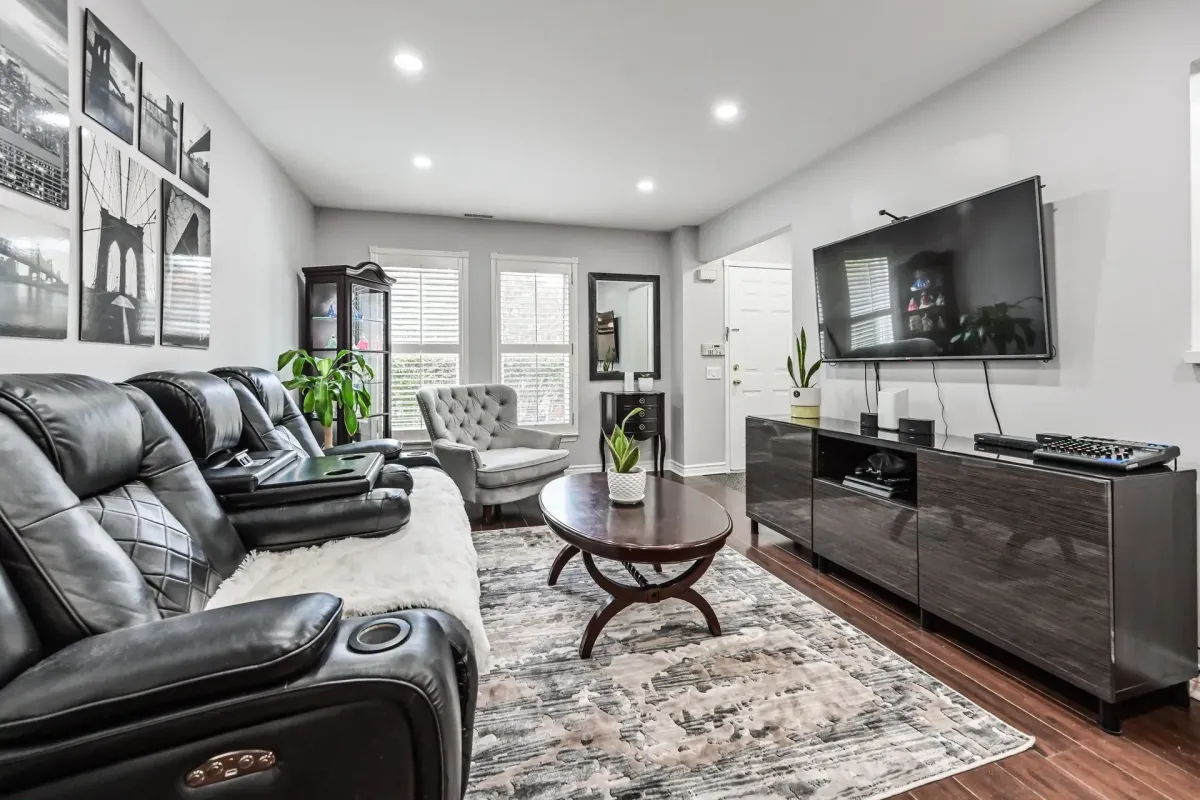 Modern seating area and media console in the sun-filled living space of 900 Steeles Ave W #112.
