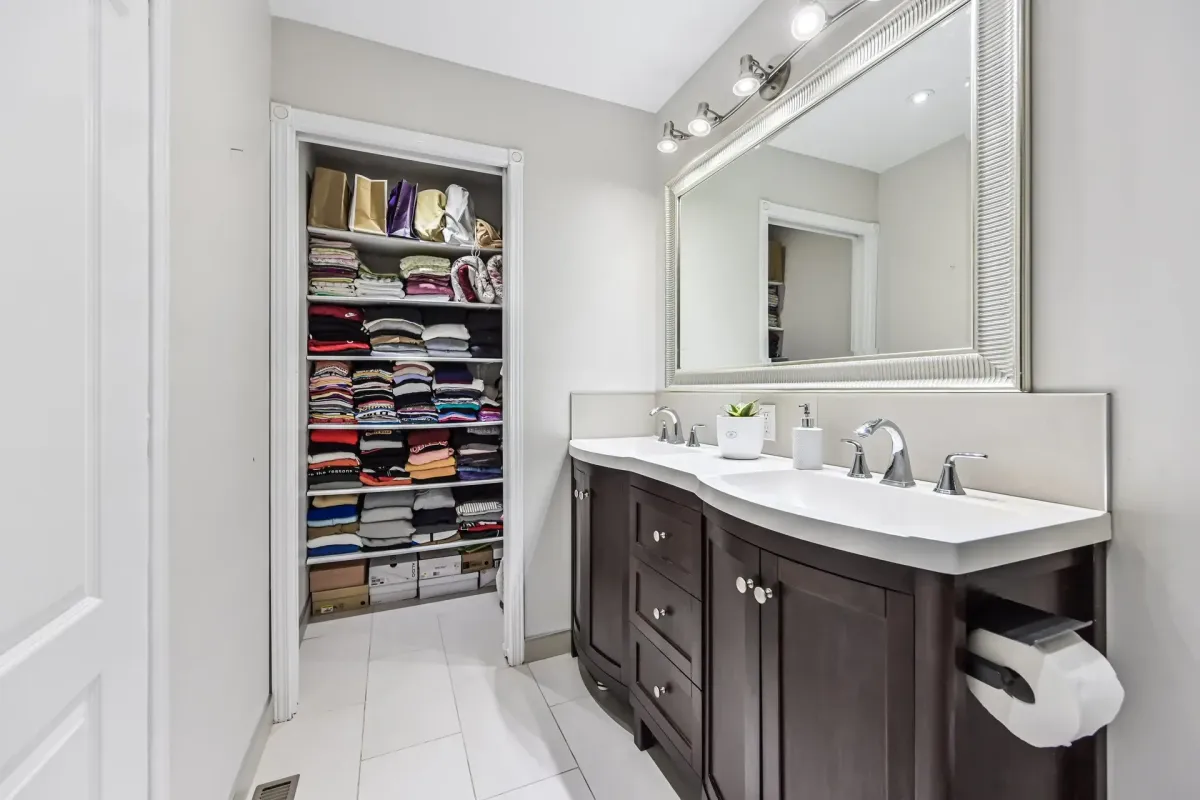 Double-sink bathroom vanity with modern lighting at 900 Steeles Ave W #112.