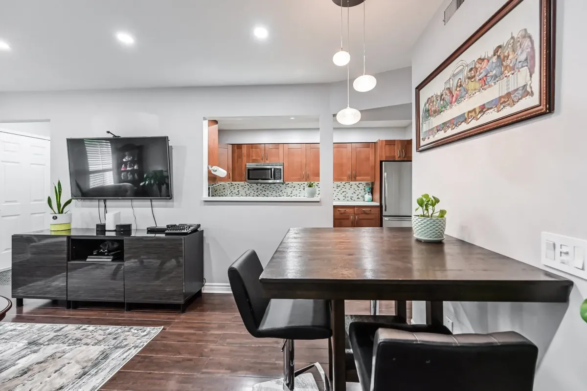 Wide perspective of the reimagined kitchen and dining space at 900 Steeles Ave W #112.