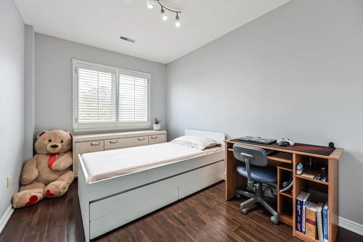 Cozy third bedroom featuring a twin bed and natural light at 900 Steeles Ave W #112.
