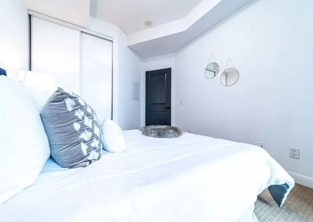 Primary bedroom at 235 Sherway Gardens Rd #401 showing the clean white walls and contemporary nightstands.
