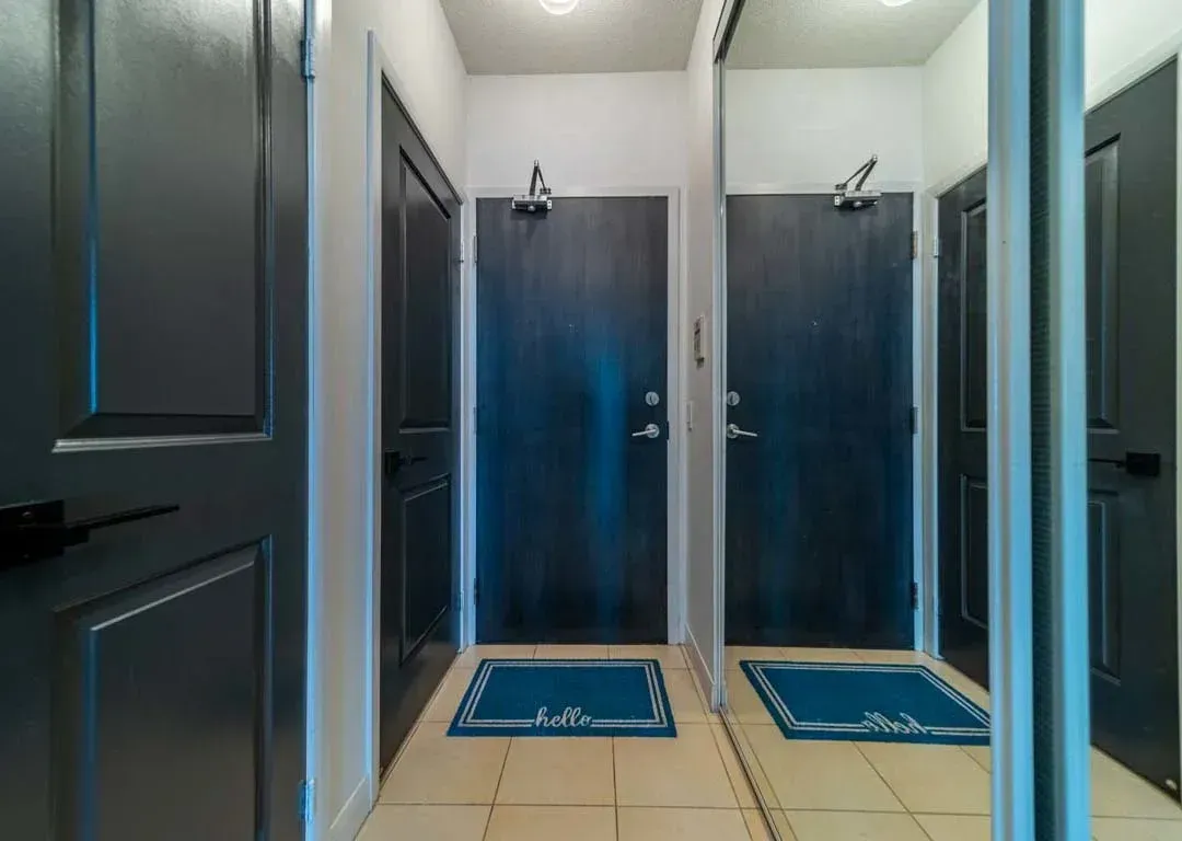 Foyer of 235 Sherway Gardens Rd #401 with dark wood doors and neutral tiling.