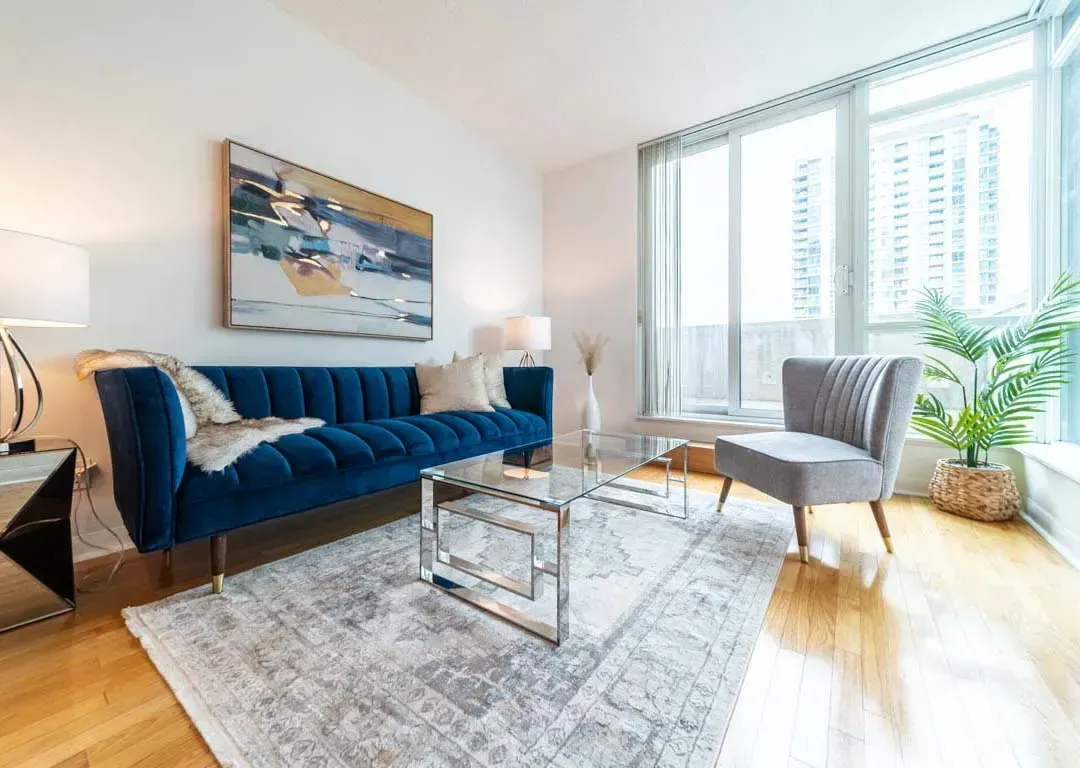 Bright living area at 235 Sherway Gardens Rd #401 with floor-to-ceiling windows and sophisticated urban decor.