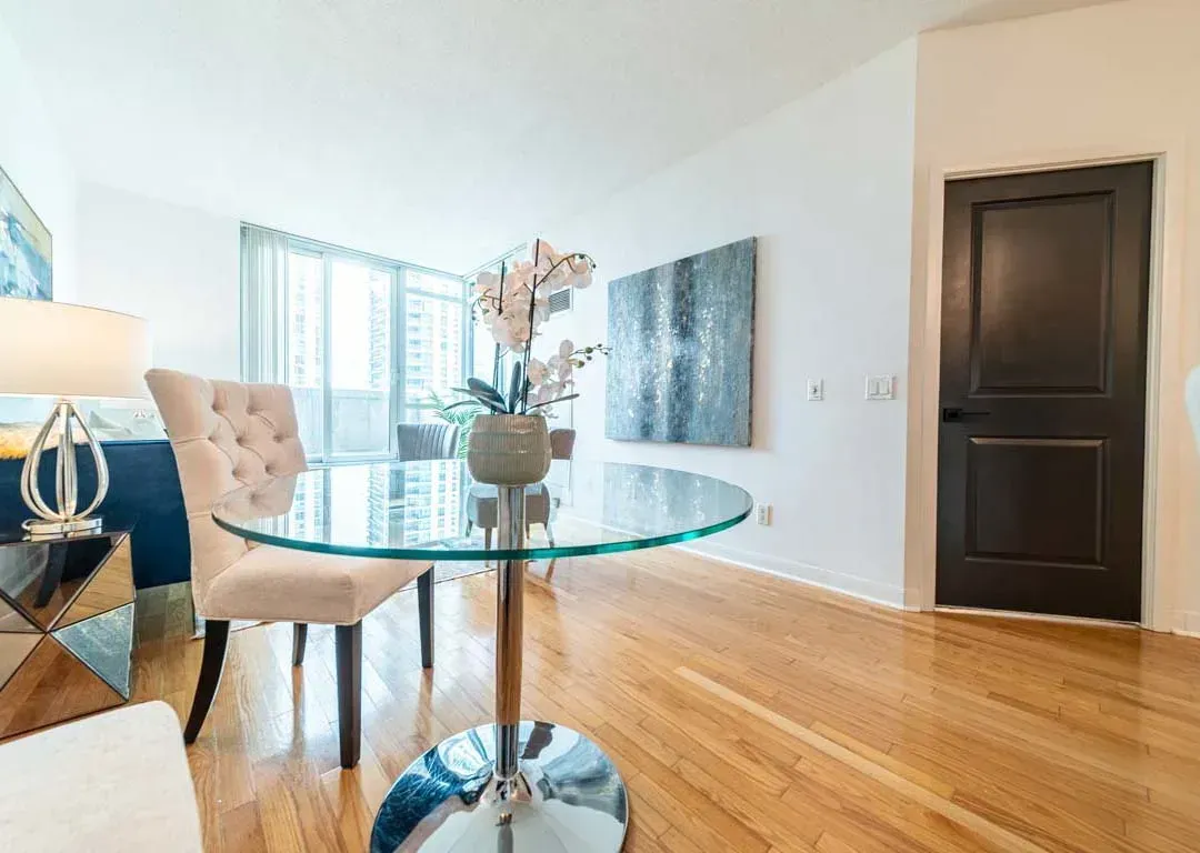Close-up of the glass dining table and modern decor accents at 235 Sherway Gardens Rd #401.