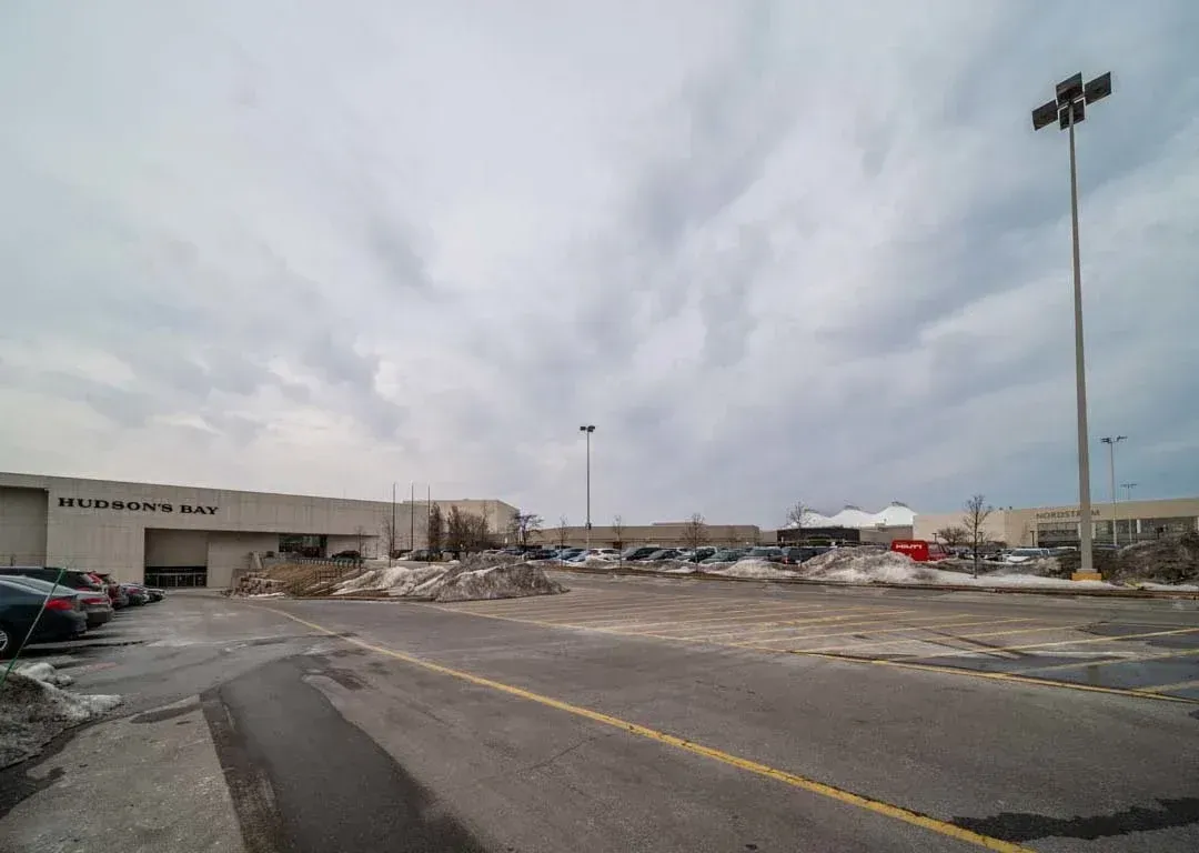 Street-level view of the parking area and commercial surroundings near 235 Sherway Gardens Rd.