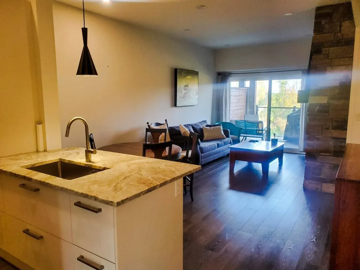 View from the gourmet kitchen at 11 Beausoleil #105 looking into the bright, open-concept living space.