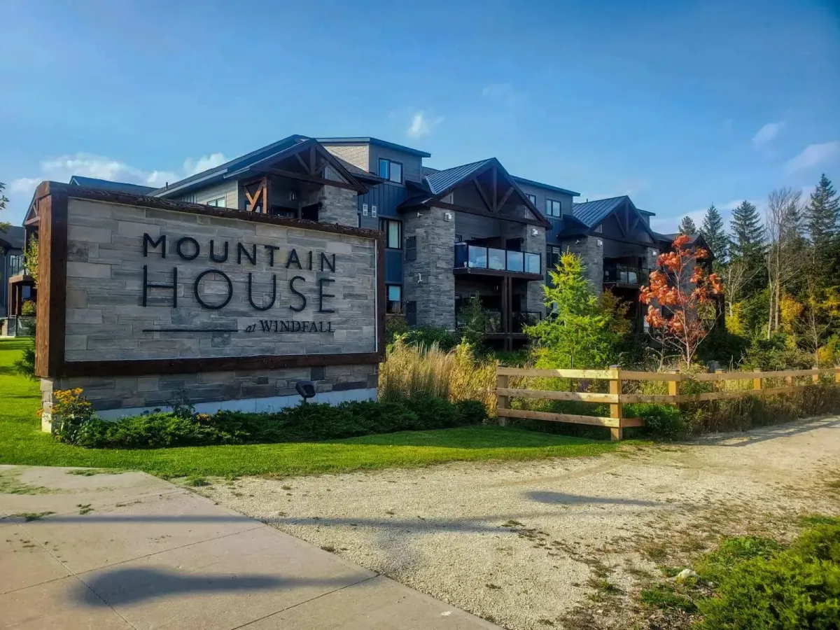 Entrance sign for "Mountain House at Windfall" at 11 Beausoleil #105, showcasing the prestigious community entrance.