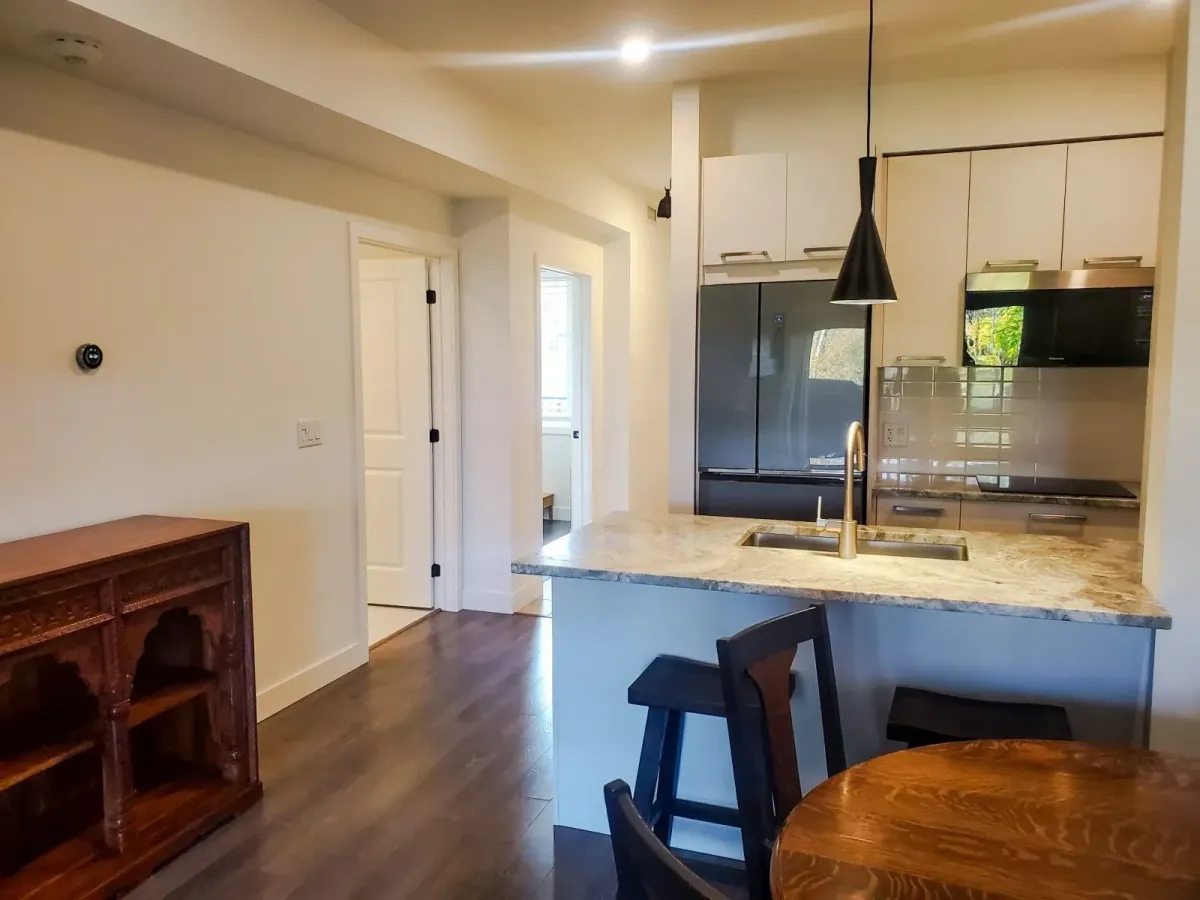 View of the kitchen at 11 Beausoleil #105 looking toward the dining area and entry hall.