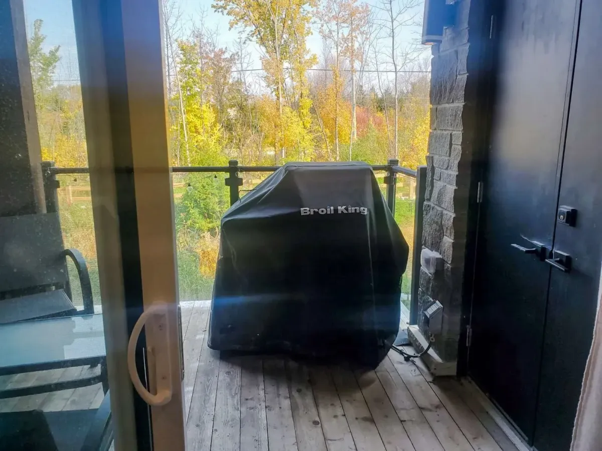 Private balcony at 11 Beausoleil #105 featuring a covered BBQ area and views of the surrounding nature.