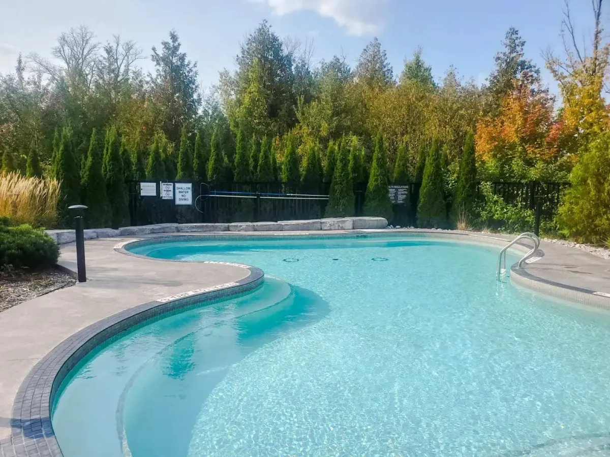 Secondary view of the expansive outdoor aquatic pool at 11 Beausoleil.