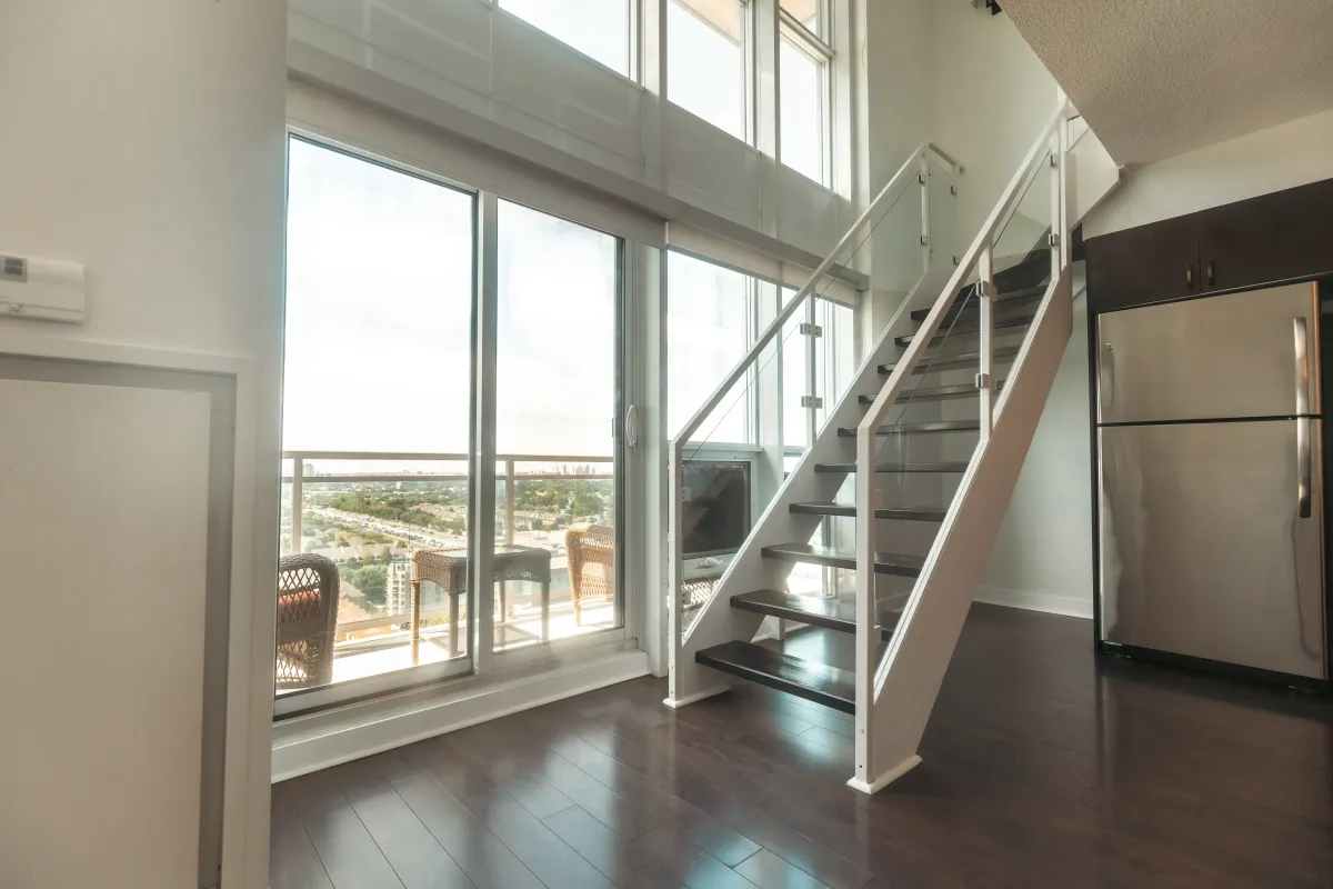 Sun-drenched main level at 155 Legion Rd N #2311 with a walk-out to the private balcony and views of Mimico.