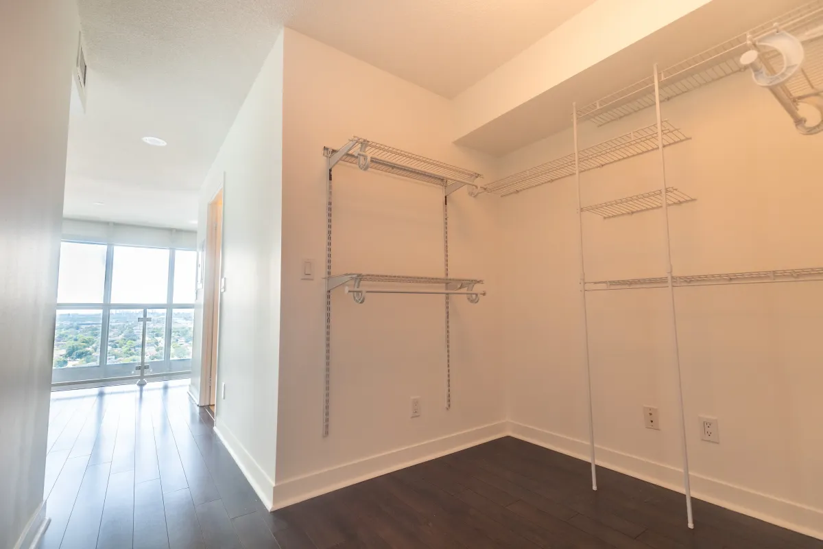 Walk-in closet in the primary bedroom of 155 Legion Rd N #2311 with built-in organization shelving.