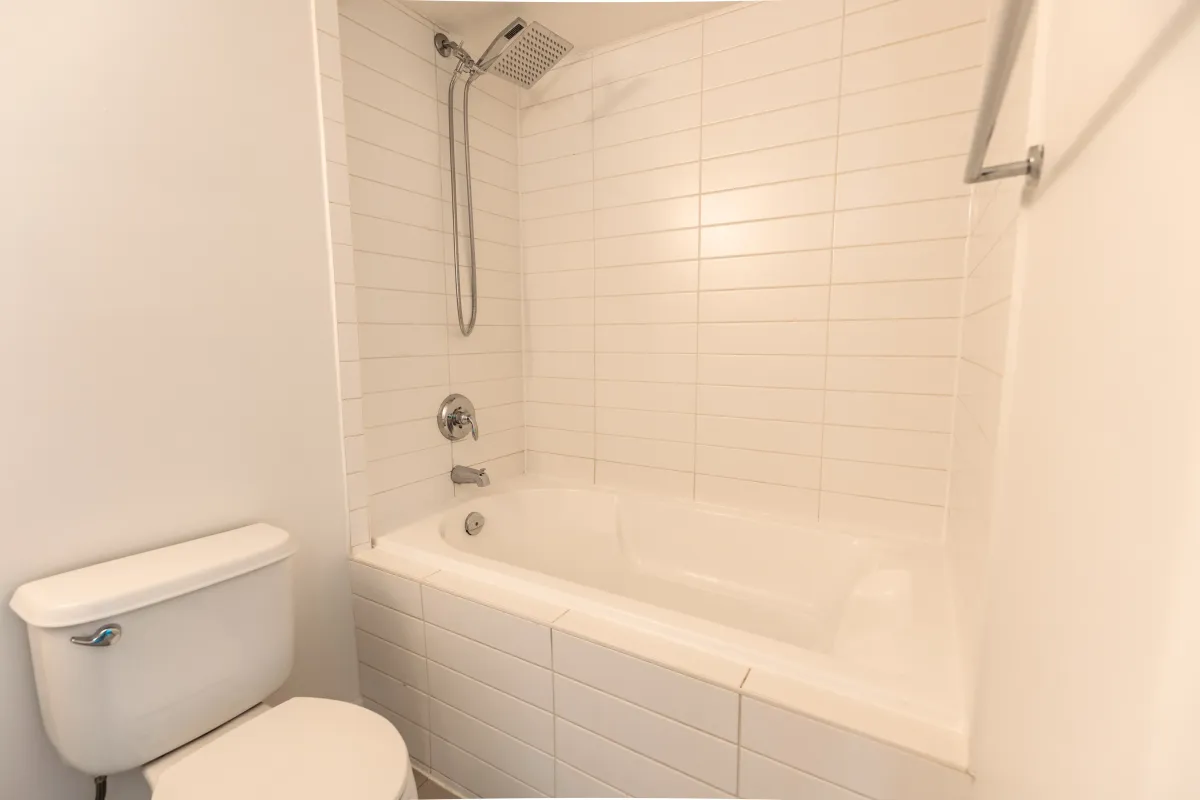 Modern 4-piece bathroom at 155 Legion Rd N #2311 featuring a large soaking tub and crisp white subway tiles.