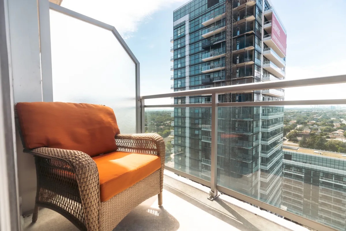 Private balcony at 155 Legion Rd N #2311 featuring a comfortable wicker chair for outdoor relaxation.