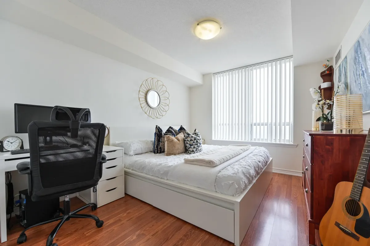Principal bedroom at 1369 Bloor St W, Suite 1416, featuring a large window, integrated workspace, and bright interior design.