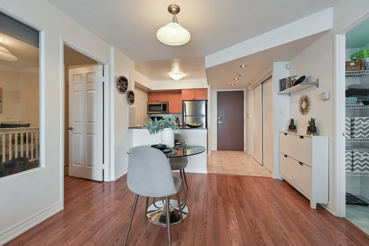 View from the dining area toward the foyer in Suite 1416 at 1369 Bloor St W, showing the spacious and airy layout.