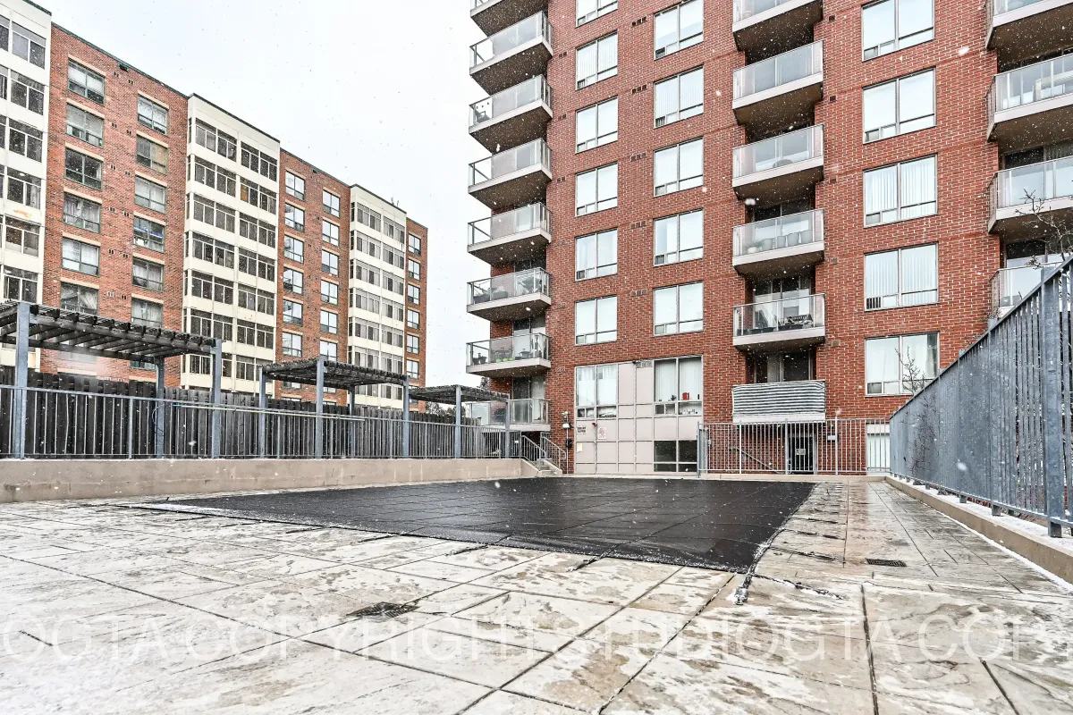 Exterior view of the building terrace and outdoor common area at the 1369 Bloor St W, Suite 1416 condo complex.