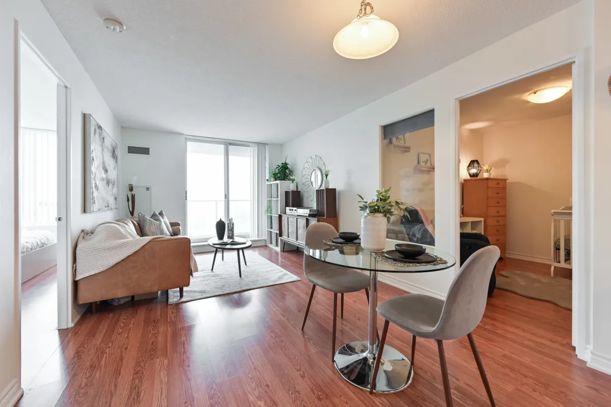 Sun-filled dining and living area at 1369 Bloor St W, Suite 1416, featuring floor-to-ceiling windows and unobstructed urban views.