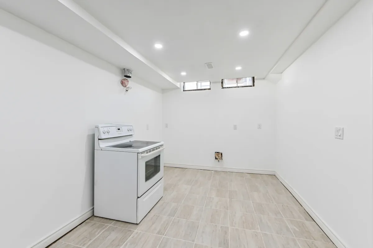 Finished basement room at 133 Howard Crescent, showcasing the recessed lighting and versatile layout.