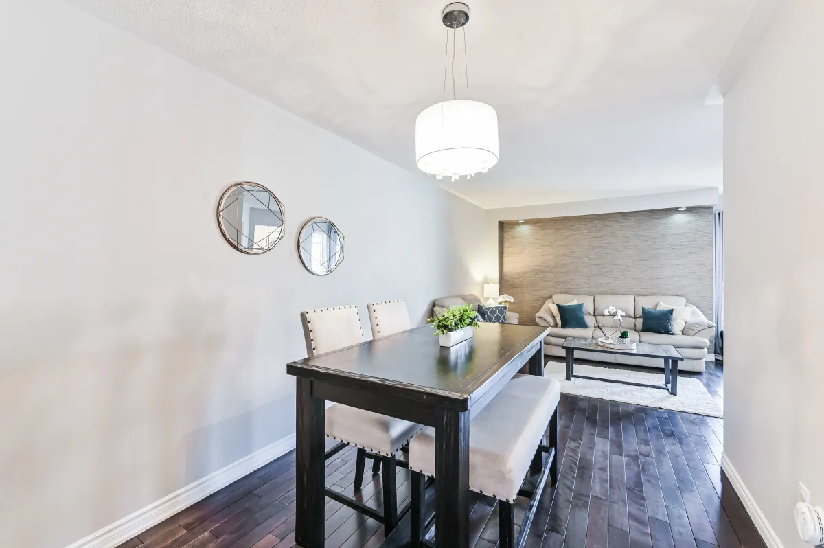 Formal dining room at 133 Howard Crescent, featuring modern lighting and a view into the family room.