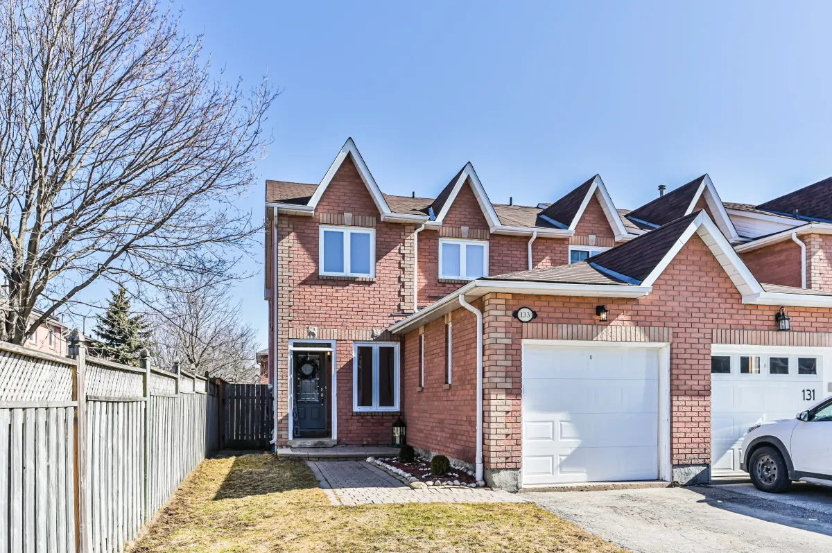 Exterior front view of 133 Howard Crescent, a stunning freehold end-unit townhouse in Orangeville with an attached garage.
