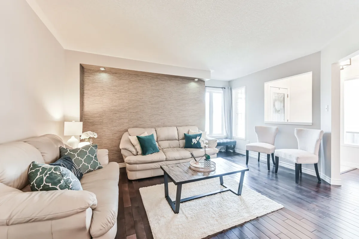 Bright and open living room at 133 Howard Crescent, featuring recessed pot lighting and neutral decor.