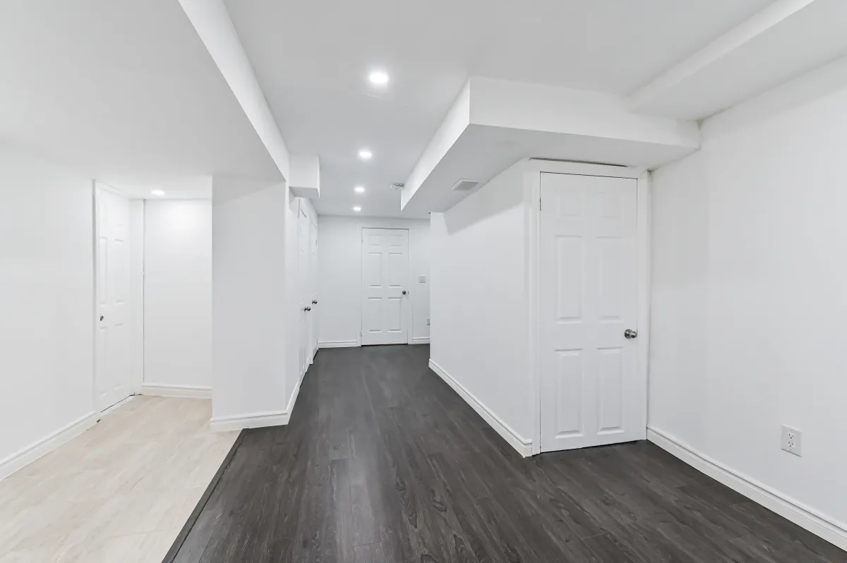 Versatile finished basement space at 133 Howard Crescent, featuring laundry area and rough-in for a 4th bathroom.