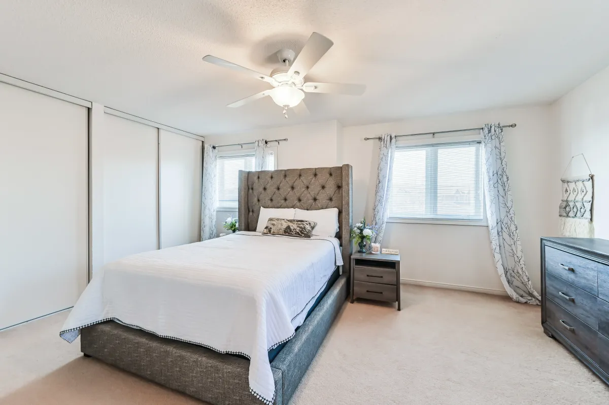Principal bedroom at 133 Howard Crescent, featuring a spacious closet and serene atmosphere.