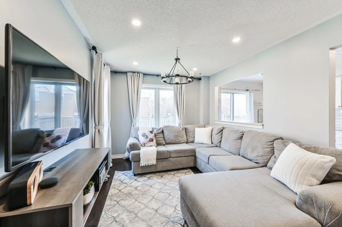 Cozy family room seating area at 133 Howard Crescent, highlighting the modern pot lights and large windows.