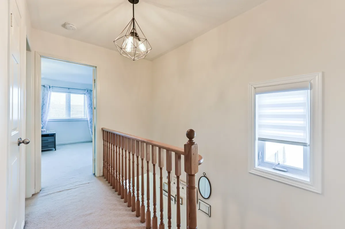 Upper level hallway at 133 Howard Crescent, connecting the three generous bedrooms and family bathroom.