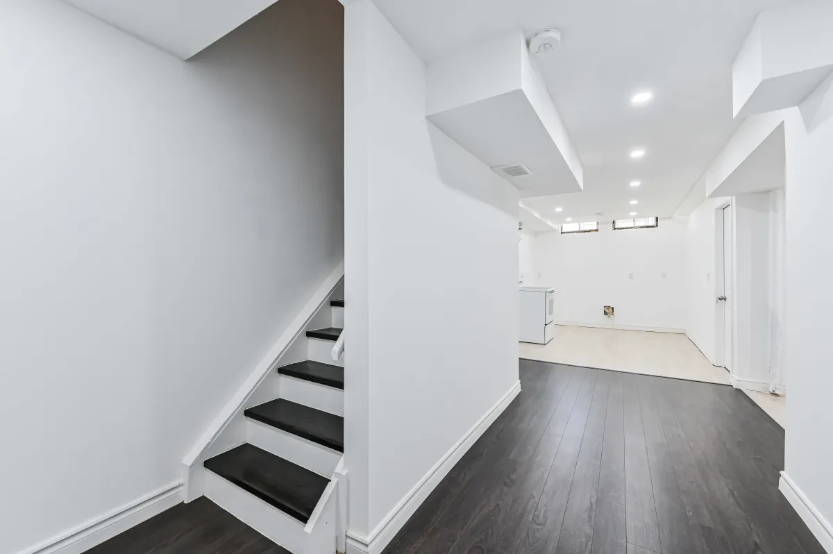 Modern staircase leading to the finished basement at 133 Howard Crescent.