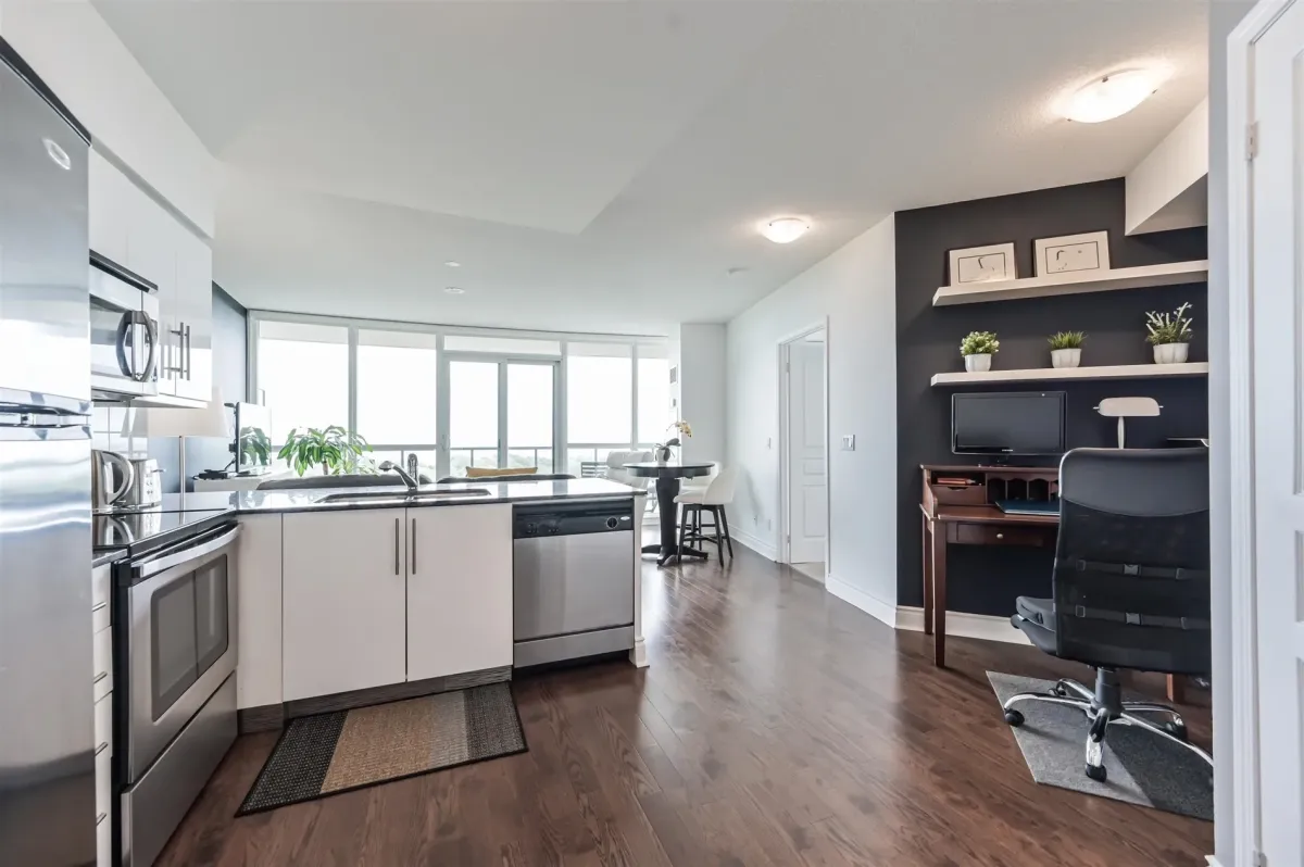 open concept kitchen, living room and den area with hardwood floors