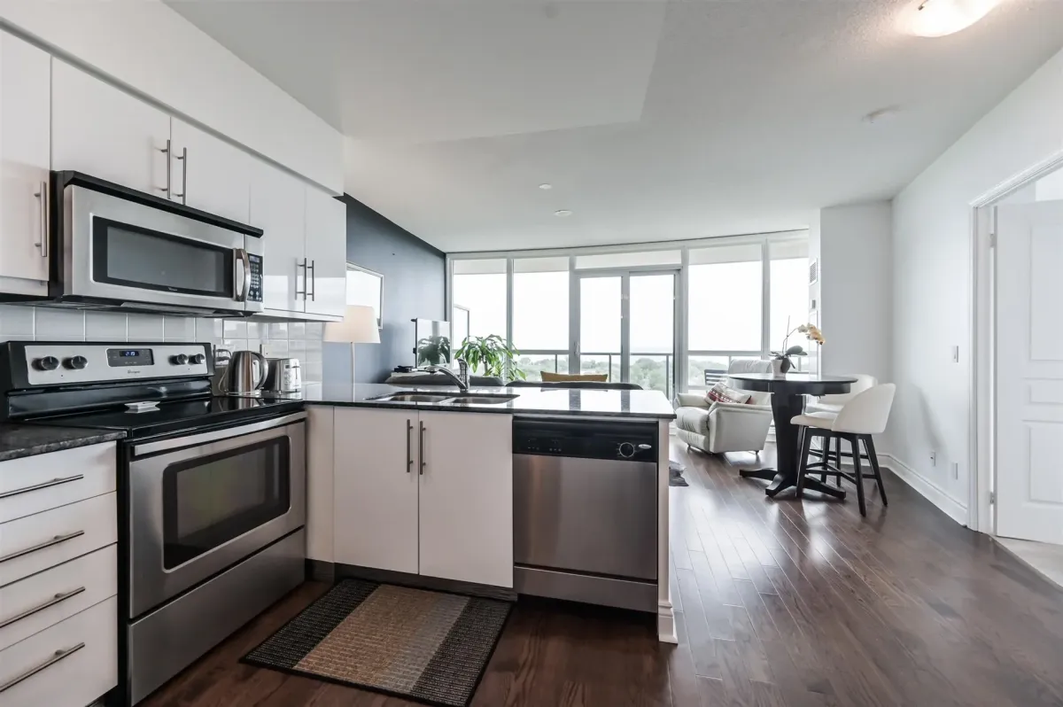 modern open concept kitchen with lake view and stainless steel appliances