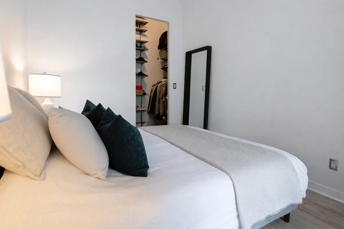 Primary bedroom with walk-in closet and barn door at Quad Lofts