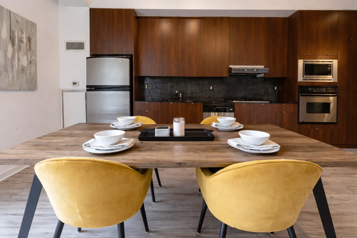 Large dining room table in open concept space at 23 Brant St, unit 305
