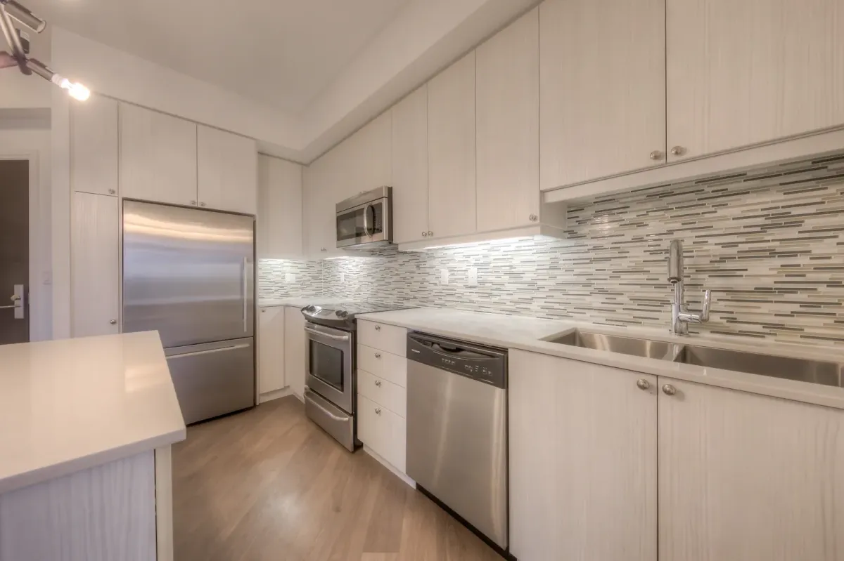 Beautiful kitchen with backsplash and stainless steel appliances 
