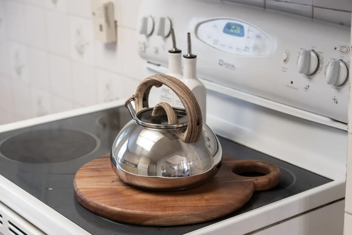 Stove with decor and kettle at 56 Hickson St.